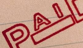 Red PAID stamp on an invoice