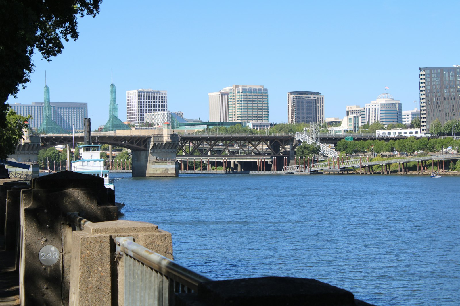 Downtown Portland, Oregon seen across the Willamette River from the Eastbank Esplanade, with the Morrison Bridge and the Oregon Convention Center spires, home to the Oregon companies whose unpaid accounts this guide is about
