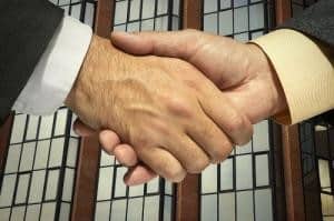 Two businessmen shaking hands to close a sale
