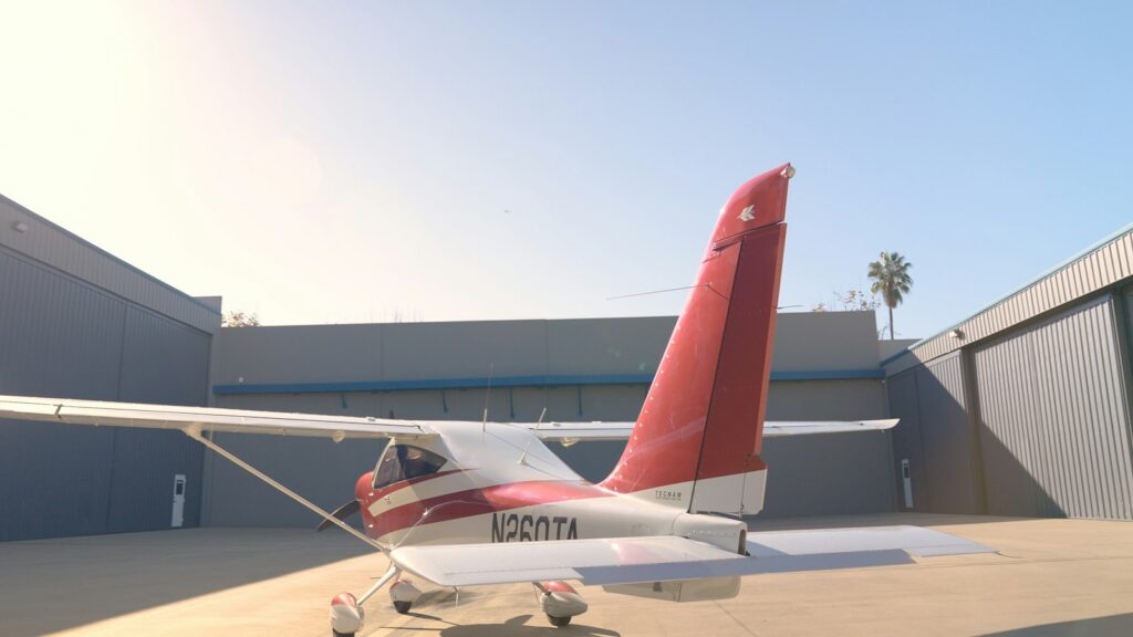 A single engine aircraft parked on the ramp outside a hangar with its N number visible on the tail, the registration that identifies the owner of record on an unpaid maintenance account