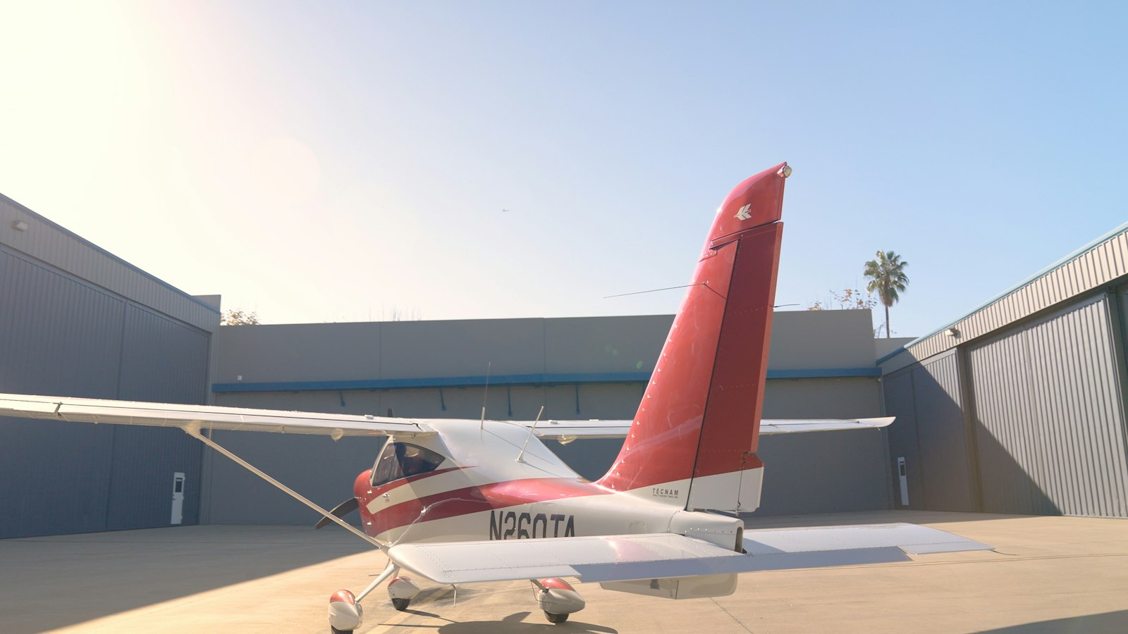 A single engine aircraft parked on the ramp outside a hangar with its N number visible on the tail, the registration that identifies the owner of record on an unpaid maintenance account